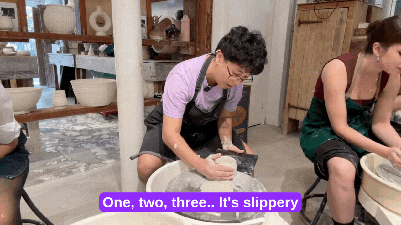 Trash making pottery and sliding a creation off the wheel.